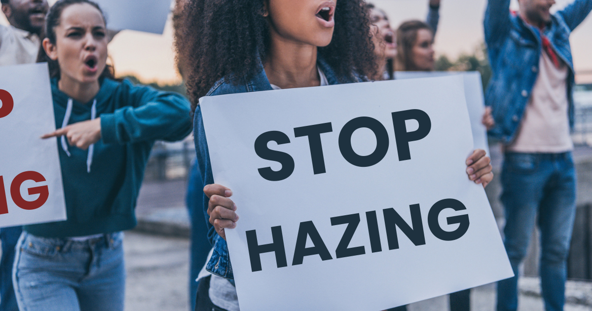 protestors hold signs that say stop hazing